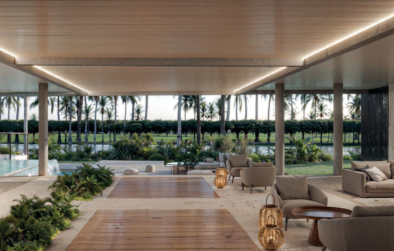 Covered outdoor lounge terrace overlooking the golf course at Reef and Golf Residences, render