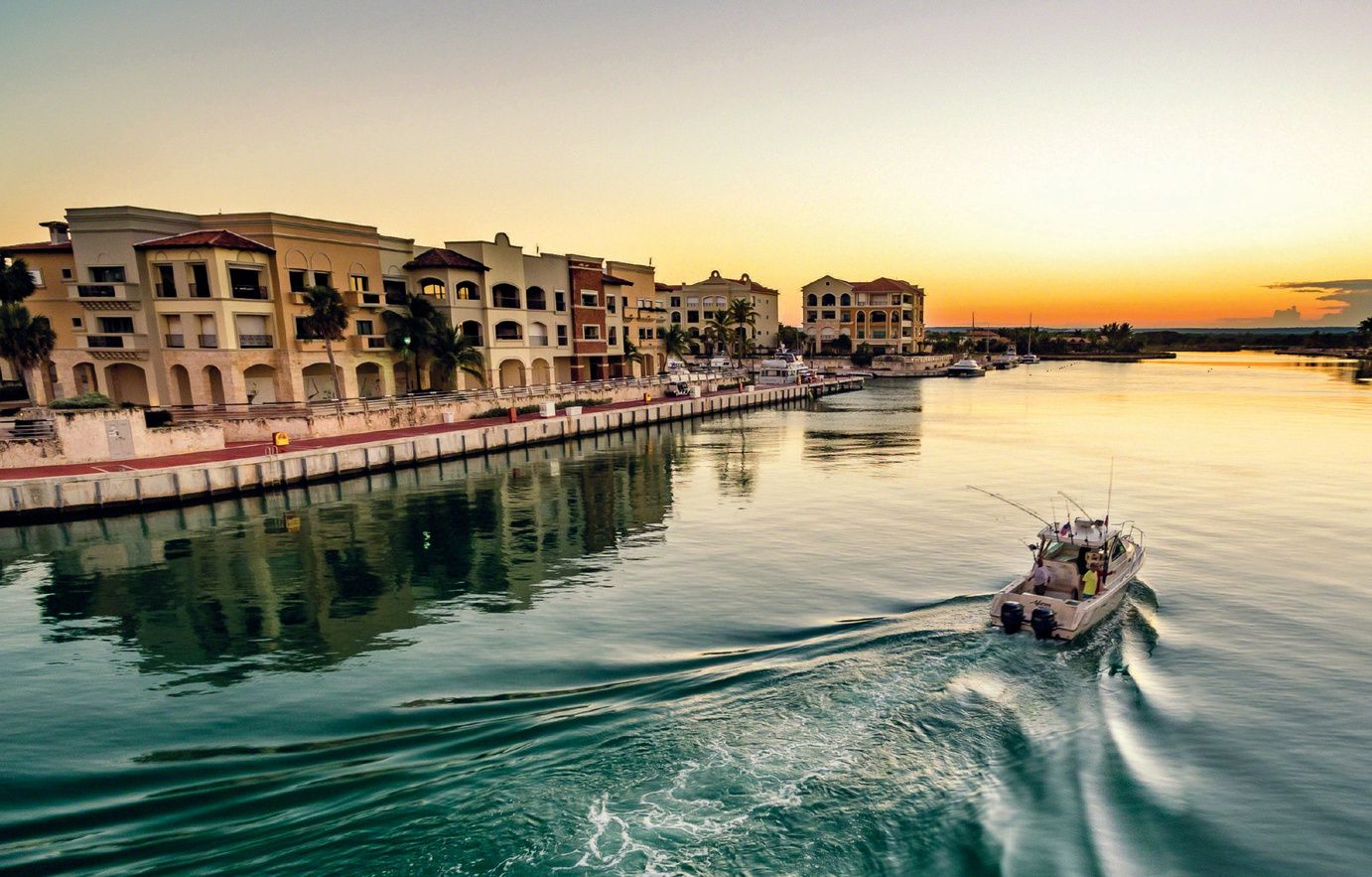Marina Cap Cana waterfront buildings at sunset, photo